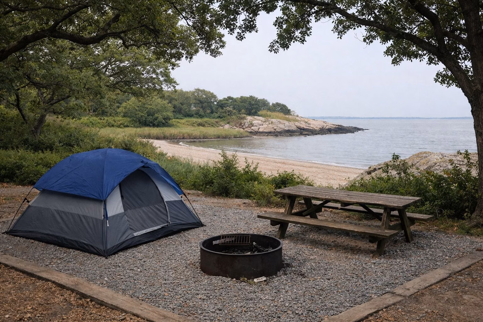 Wooded campsite with a tent, picnic table and fire ring under oak trees