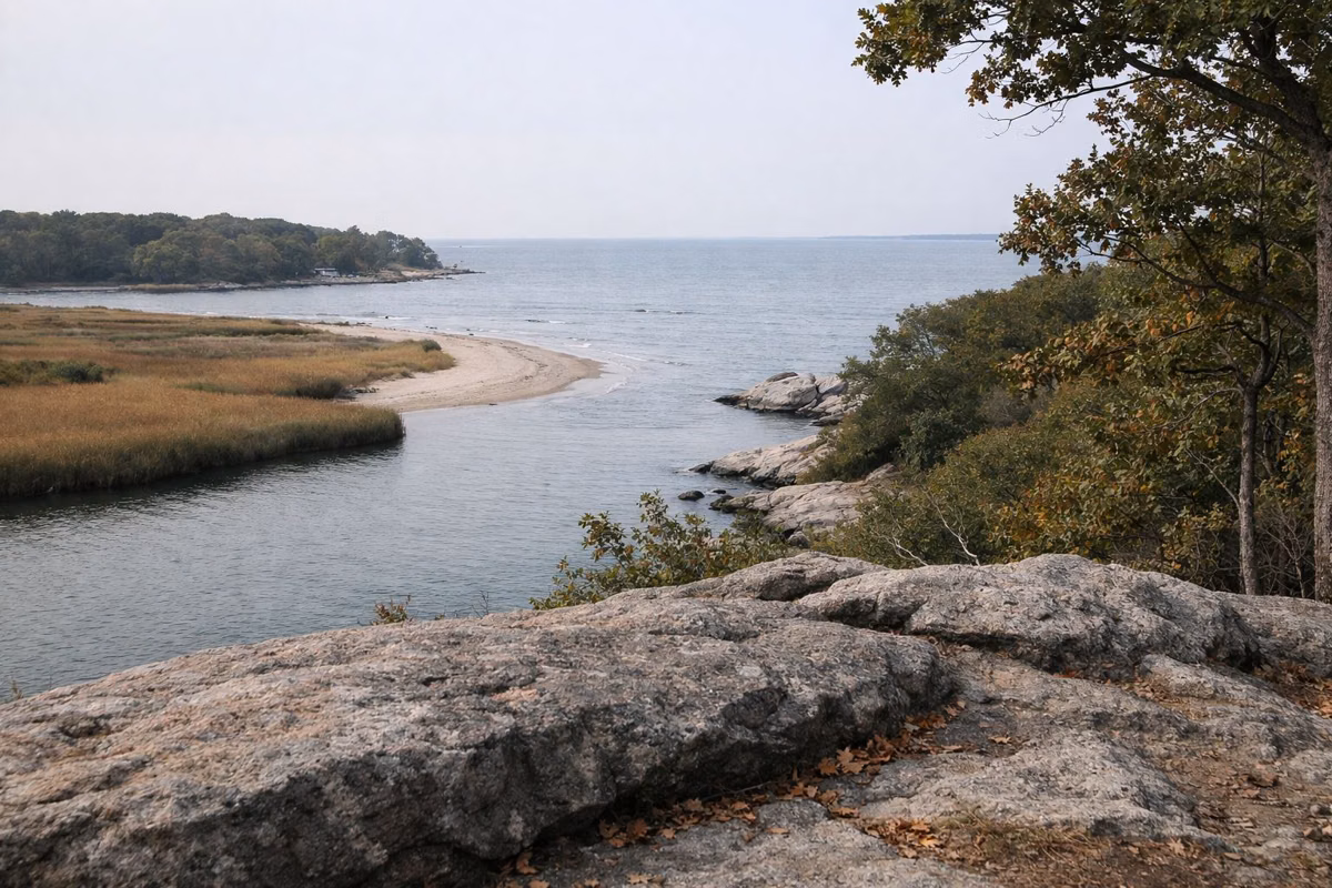 Granite ledge overlook above a tidal river meeting the sound