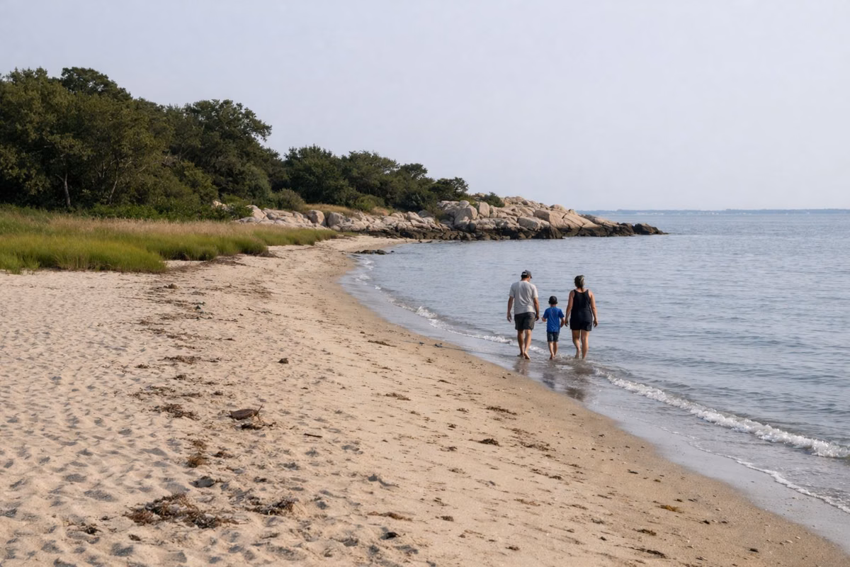 Family walking along the edge of a sandy beach
